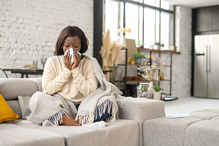 Woman sneezing and resting from a cold.